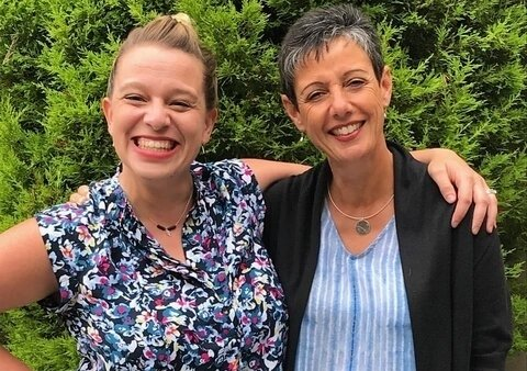 Two women posing together representing company leadership
