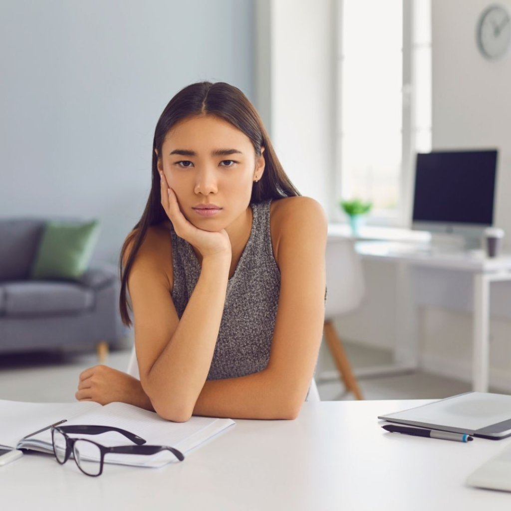 Unmotivated young lady working from home